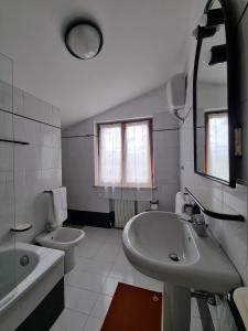 a white bathroom with a sink and a toilet at Casa Vanda in San Lorenzo