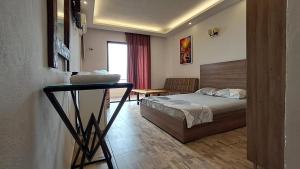 a bedroom with a bed and a table in a room at Byblos inn, jbeil ,Fidar in Al Fīdār +36 photos