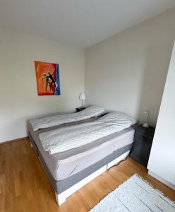 a bedroom with a bed and a painting on the wall at The Seabreeze Marina in Mandal +27 photos