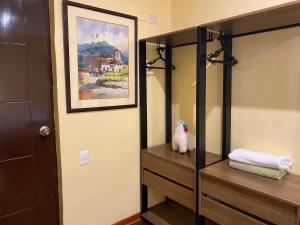 a bathroom with a mirror and a cat sitting on a shelf at Posada Miraflores in Lima +175 photos