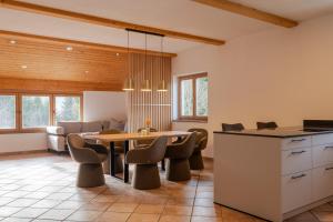 a kitchen and dining room with a table and chairs at Alps Living Söll in Söll