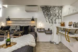 a bedroom with a large bed and a curtain at Oasis Hideaway Apt w/ Rainforest Shower! in Baltimore