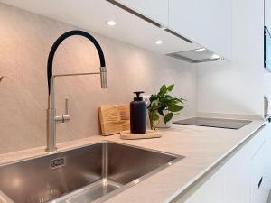 a kitchen sink with a black bottle on a counter at Casa PedraParda in O Grove