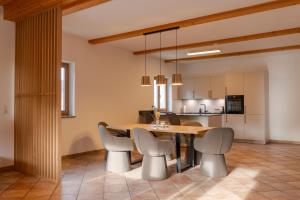 a kitchen and dining room with a table and chairs at Alps Living Söll in Söll