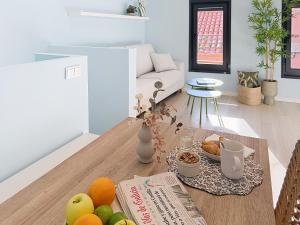 a living room with a table with fruit on it at Casa PedraParda in O Grove +12 photos