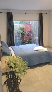 a bedroom with a bed and a window at Camisão CasaJuMa Pixixi in Aquidauana