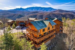an aerial view of a house with mountains in the background at Massive Cabin Indoor Pool Driving Simulators Sleeps 20 in Gatlinburg