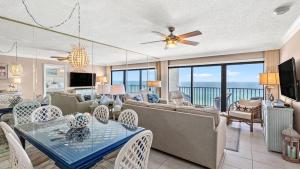 a living room with a couch and a table at Beachfront Breeze by AvantStay in Panama City Beach