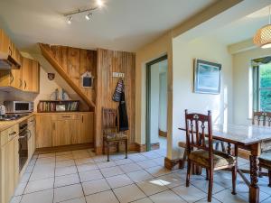 a kitchen with a wooden table and a dining room at Elm View in Chipping Campden +26 photos
