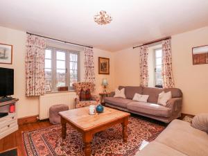 a living room with a couch and a coffee table at Elm View in Chipping Campden