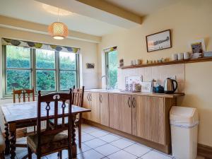 a kitchen with a table and a dining room at Elm View in Chipping Campden