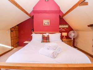 a bedroom with a bed with towels on it at Elm View in Chipping Campden