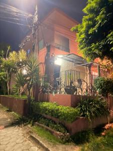 a house with a fence in front of it at night at RESIDENCIAL SOPHIA in Eunápolis