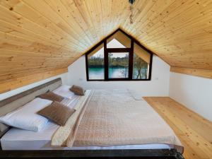 a large bed in a room with a wooden ceiling at Apartment Padre e hija in Ponari +14 photos