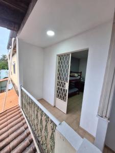 a stairway leading to a room with a door at Casa com Quarto Duplo com Banheiro Privativo in Rio de Janeiro
