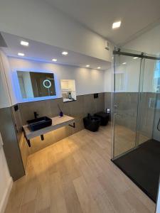 a bathroom with a sink and a glass shower at Windofsand Room in Cagliari +38 photos