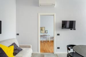 a white living room with a couch and a table at Suite Andrea-Luxury Central Suite in Bergamo +8 photos