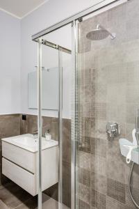 a bathroom with a glass shower and a sink at Suite Andrea-Luxury Central Suite in Bergamo