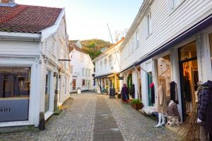 a cobblestone street in a town with white buildings at The Seabreeze Marina in Mandal
