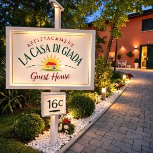 a sign for a guest house in front of a building at LA CASA DI GIADA - uscita autostrada di Imola - self check in - parcheggio privato in Imola