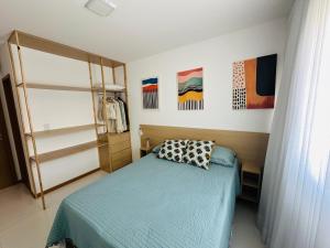 a bedroom with a bed with a pillow on it at Casa da Alê in Camaçari +28 photos