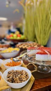 a table topped with plates of food and desserts at מלון אבא תל-אביב-יפו in Tel Aviv +24 photos