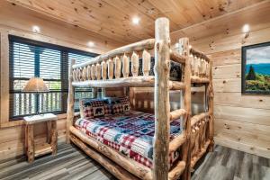 a bedroom with a bunk bed in a log cabin at Massive Cabin Indoor Pool Driving Simulators Sleeps 20 in Gatlinburg +66 photos