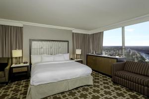 a hotel room with a bed and a couch at Hilton Niagara Falls/ Fallsview Hotel and Suites in Niagara Falls +27 photos