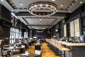 a restaurant with tables and chairs and a large chandelier at Hilton Niagara Falls/ Fallsview Hotel and Suites in Niagara Falls