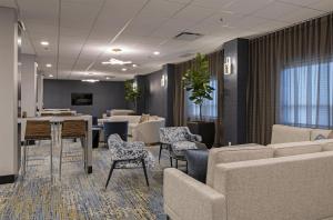 a waiting room with chairs and a table and a couch at DoubleTree by Hilton West Edmonton in Edmonton