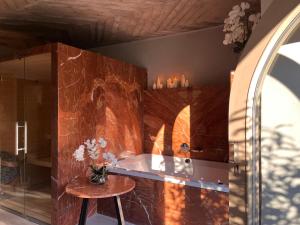 a room with a table and a stone wall at Brána historic Boutique Apartments in Horažďovice +19 photos