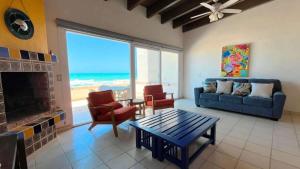 a living room with a couch and a fireplace at Cozy & Colorful Beachfront Condo Las Olas II 4 in Puerto Peñasco