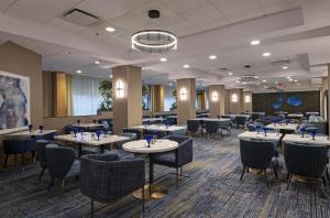 a restaurant with tables and chairs in a room at DoubleTree by Hilton West Edmonton in Edmonton