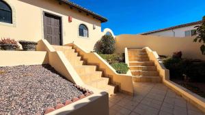 a set of stairs in front of a house at Charming 3-Bedroom Beachfront Home Bahia Delfin in Las Conchas