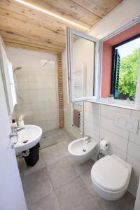 a bathroom with a white toilet and a sink at LA CASA DI GIADA - uscita autostrada di Imola - self check in - parcheggio privato in Imola