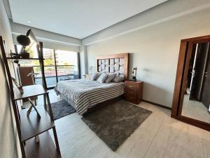 a bedroom with a bed and a large window at Condo in Bucerías Beachfront Narval Norte in Bucerías +37 photos