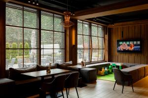a restaurant with couches and tables and a play area at Wood Hotel Resort & SPA in Bukovel