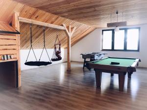 a room with a pool table in a room with a ceiling at Willa Bosmański Zakątek in Tałty