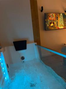 an aquarium in a room with blue lights at EPICENTAR Luxury Jacuzzi & Sauna Apartment in Baščaršija - Private Spa Experience in Sarajevo +11 photos