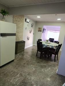 a kitchen and dining room with a table and a refrigerator at Casa Ruta 3 Río Gallegos in Río Gallegos