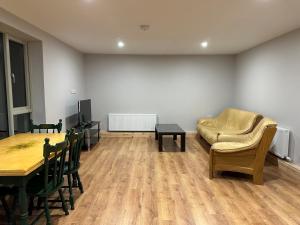 a living room with a table and a couch at Ocean view apartment in Tralee