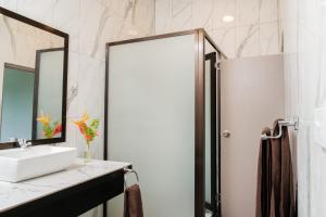 a bathroom with a sink and a mirror at Raluve BnB in Rakiraki