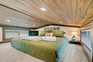 a bedroom with a large bed with a wooden ceiling at Pigeon Forge Landing RV Resort in Pigeon Forge +263 photos