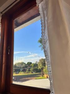 a window with a view of a street at Raíces Vivas Selva Misionera in Oberá +10 photos