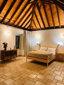 a bedroom with a bed and a wooden ceiling at Faro Town House in Faro