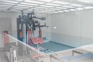 a room with a gym with a chair and skis at Sesimbra Ocean Terrace in Sesimbra