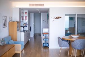 a kitchen and dining room with a table and chairs at Sesimbra Ocean Terrace in Sesimbra