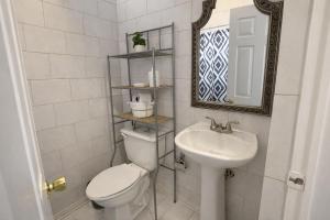 a bathroom with a toilet and a sink at Casa Real in Manuel F. Martínez +17 photos