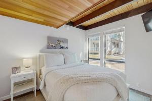 a white bedroom with a bed and a window at The Cozy King in Kings Beach +28 photos