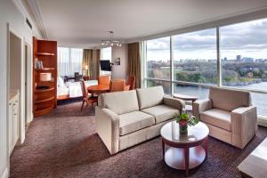 a living room with couches and a room with a view at Hilton Lac-Leamy in Gatineau